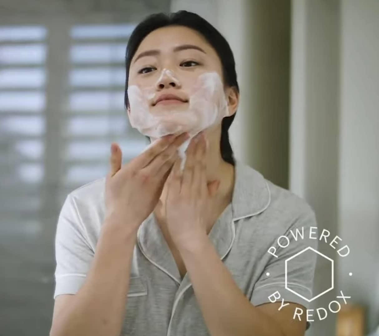 A woman applying the RenuAdvanced Foaming Face Cleanser, as part of her skin care routine!