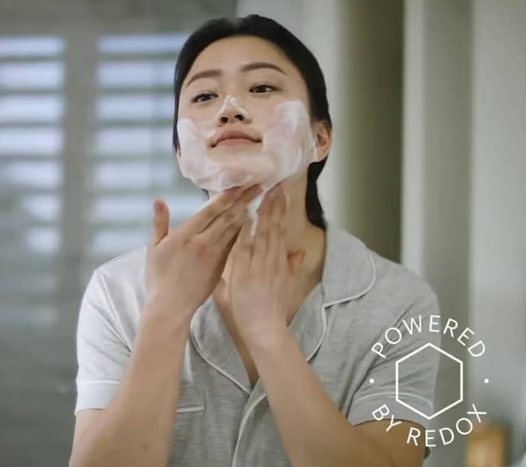 A woman applying the RenuAdvanced Foaming Face Cleanser, as part of her skin care routine!